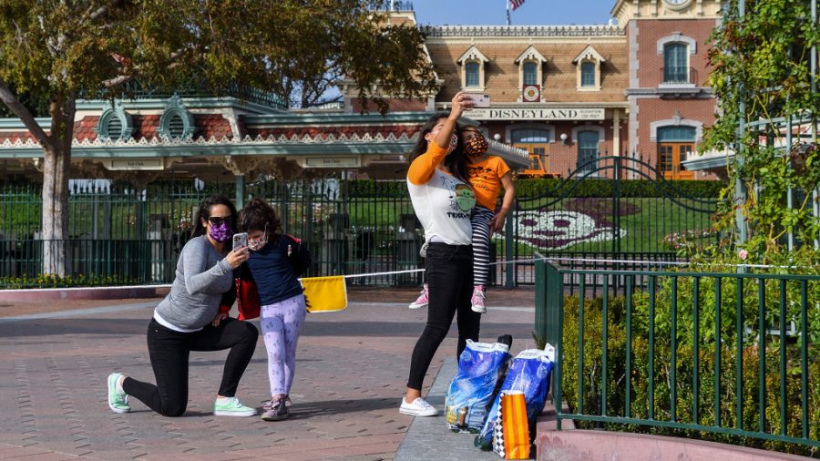 Stephanie Powers, left and her daughter Alani Powers, 4, and Brittany Losey and her daughter Madison Losey, 7, take pictures outside the entrance to Disneyland at the Disneyland Resort is closed in Anaheim, CA, on Thursday, October 22, 2020. (Photo by Jeff Gritchen, Orange County Register/SCNG)